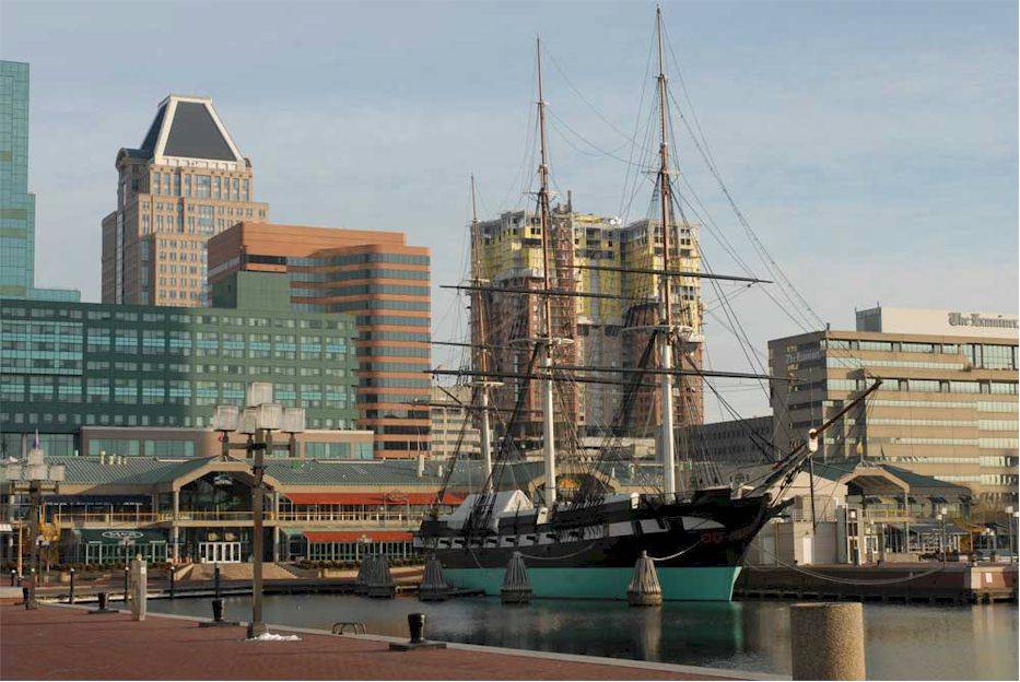 A tall ship docked in a harbor.