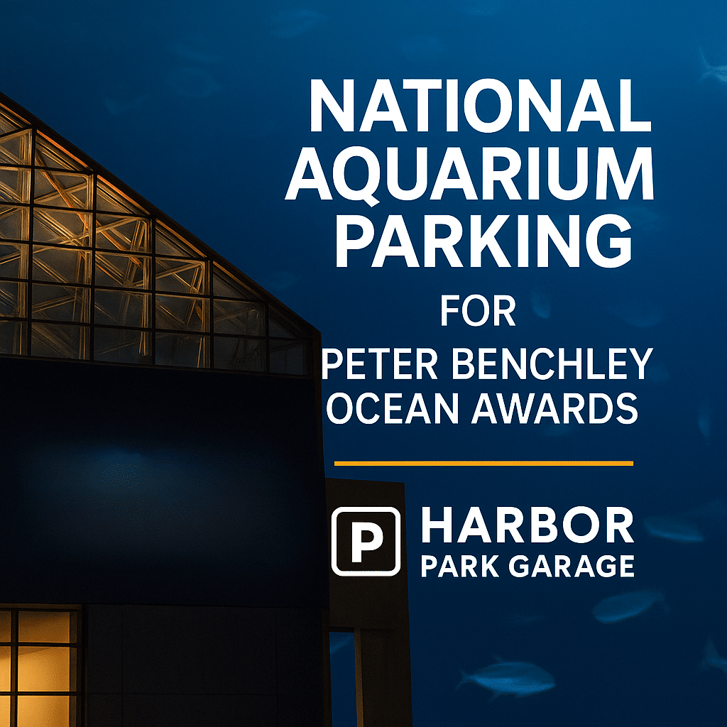 Sign showing National Aquarium parking for Peter Benchley Ocean Awards at Harbor Park Garage, with part of a building visible against a blue sky.