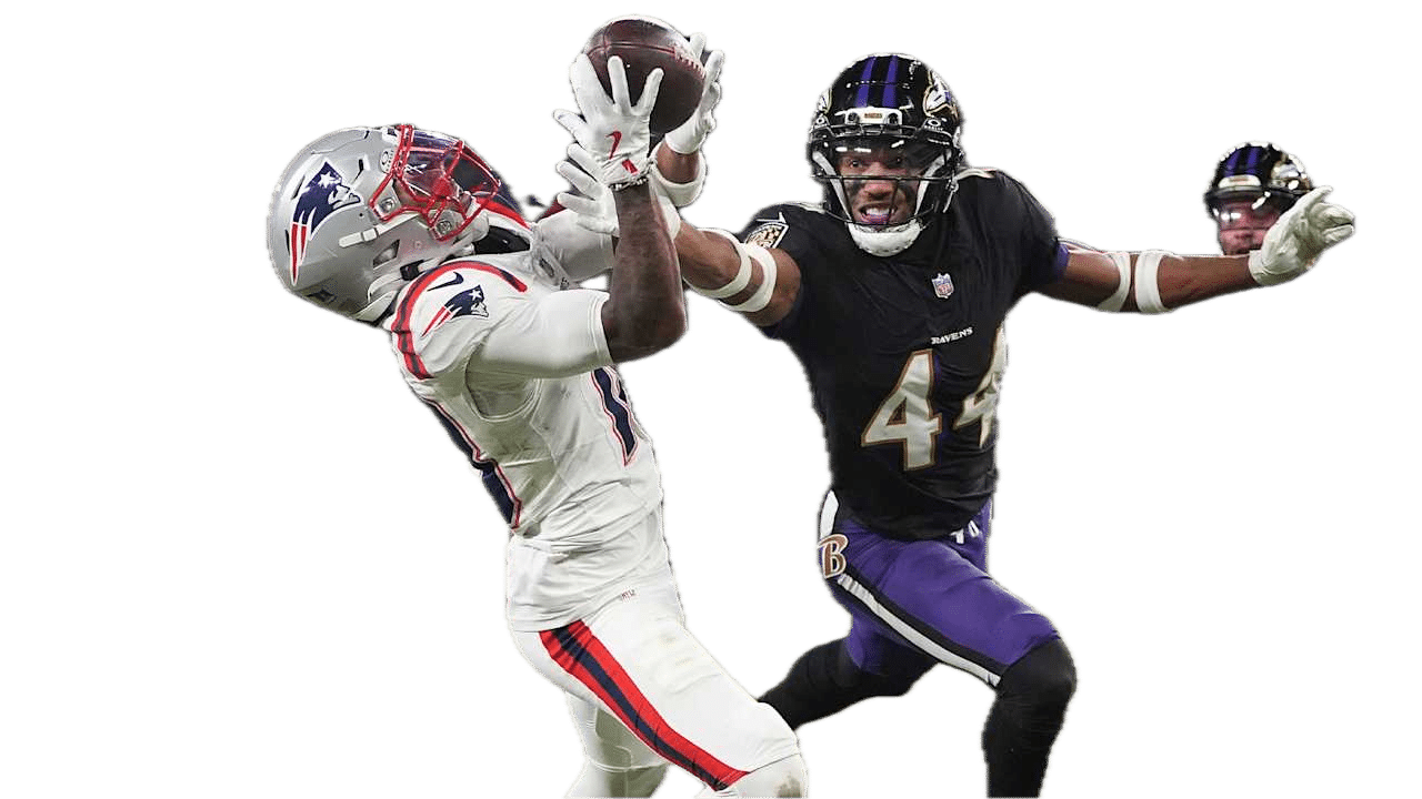 A football player in a Patriots uniform catches a pass while a Ravens defender attempts to block him during a game.